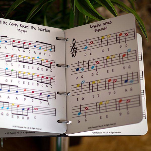 A large music book to accompany an outdoor musical instruments using a rainbow scale