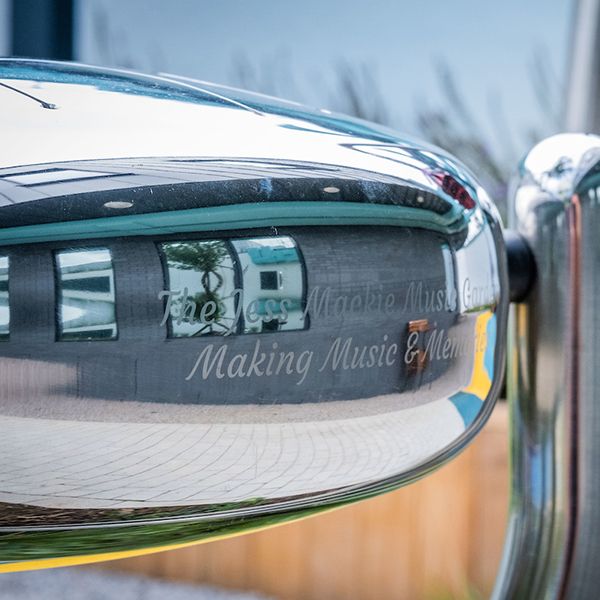 side of a stainless steel tongue drum engraved Jess Mackie Music Garden