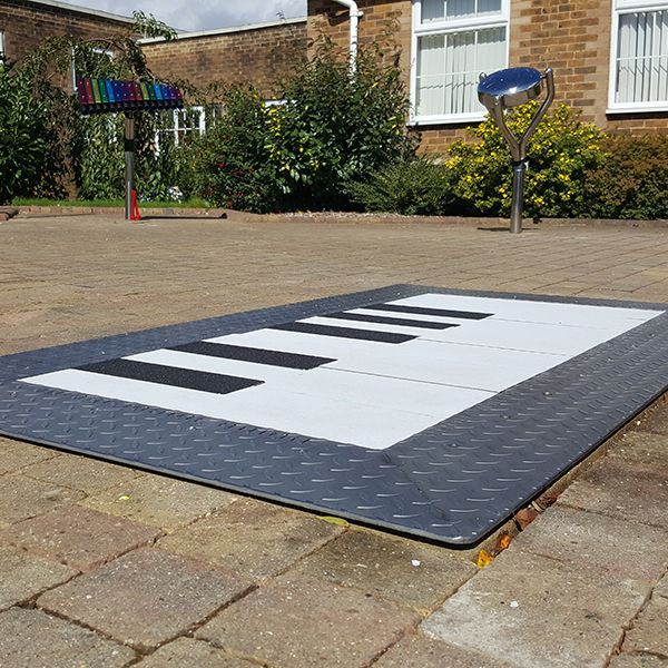 Large floor piano installed in a special needs school playground