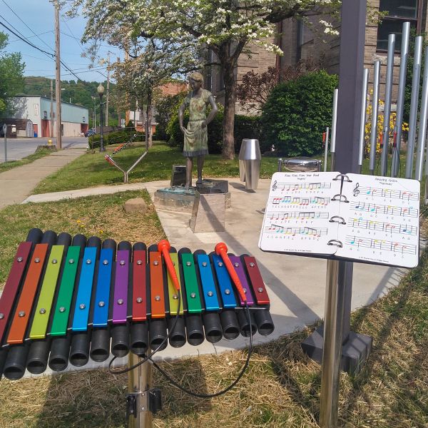 rainbow coloured large outdoor xylophone installed outside the oil city public library