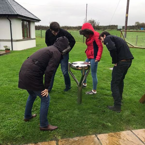 Kier family looking at the inscription on the Babel Drum at Calums Cabin Isle of Bute 