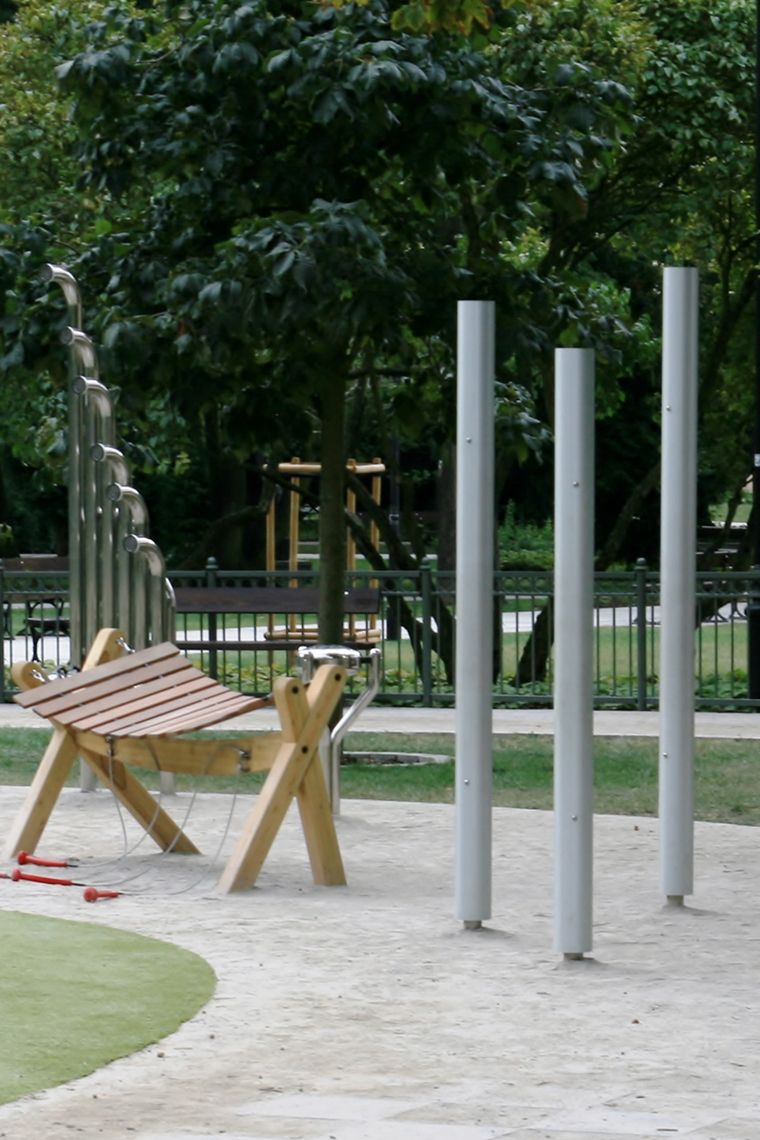 Three silver chimes installed in a children's playground