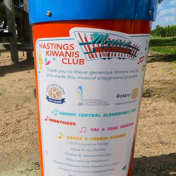 a large outdoor drum with a sticker on showing the volunteers and donors responsible for the eight outdoor musical playgrounds installed Summer 2020