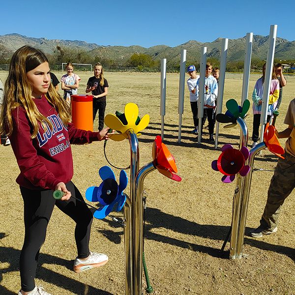 pupils from Tanque Verde School playing large outdoor musical flowers in their new outdoor music classroom