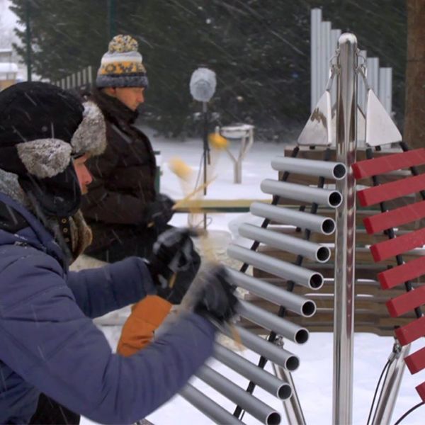 Outdoor xylophone with three sets of keys cascading from one central post in a music park in Finland