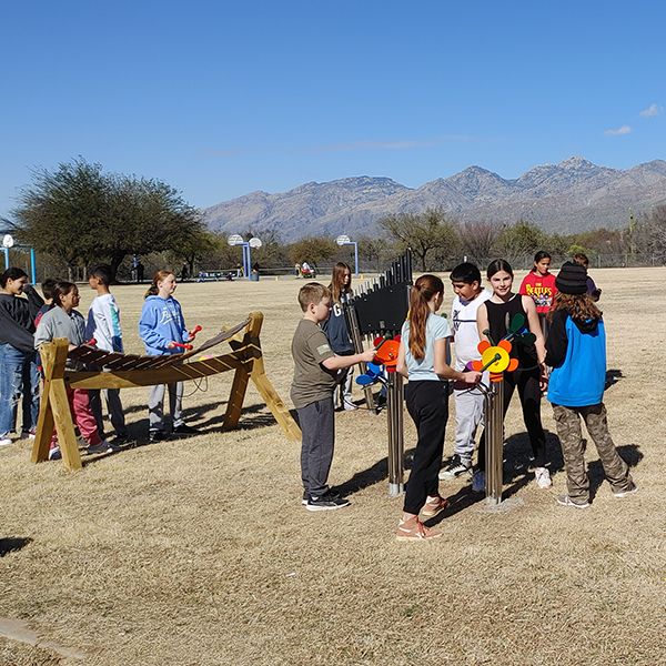 pupils from Tanque Verde School playing large outdoor musical instruments in their new outdoor music classroom