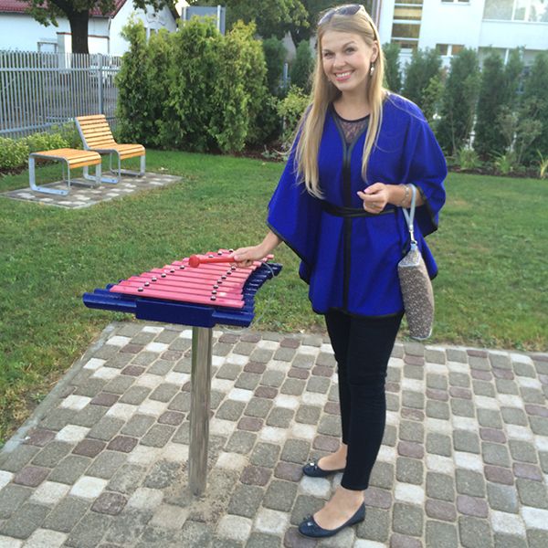 Young lady playing an outdoor xylophone from Percussion Play