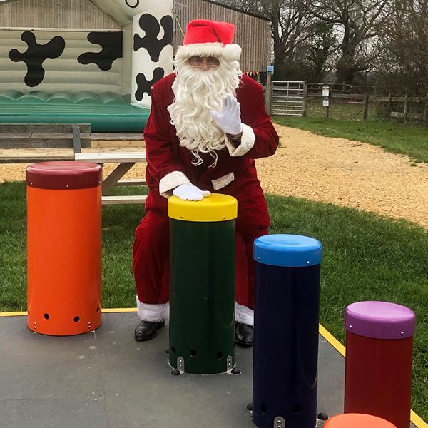 image of Father Christmas playing outdoor drumsat Farmer Palmers Farm Park