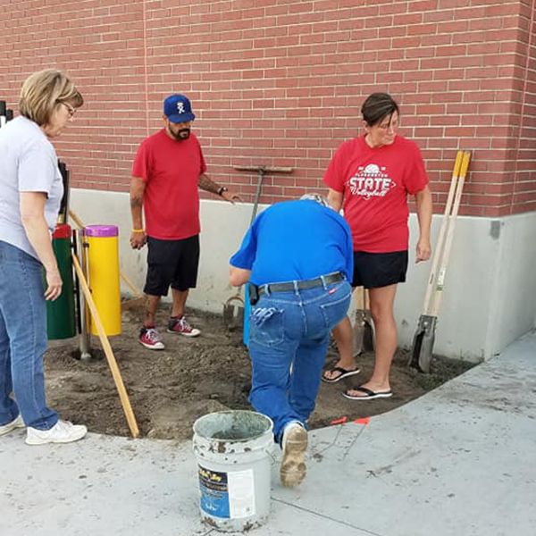 Volunteers from Pleasanton Lions Club installing four outdoor musical instruments in the school playground