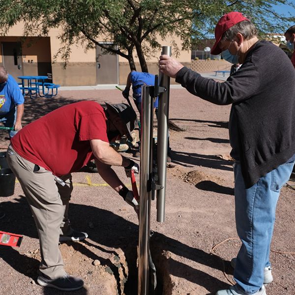 members of the Valle Verde Rotary Club installing outdoor musical instruments ready to install