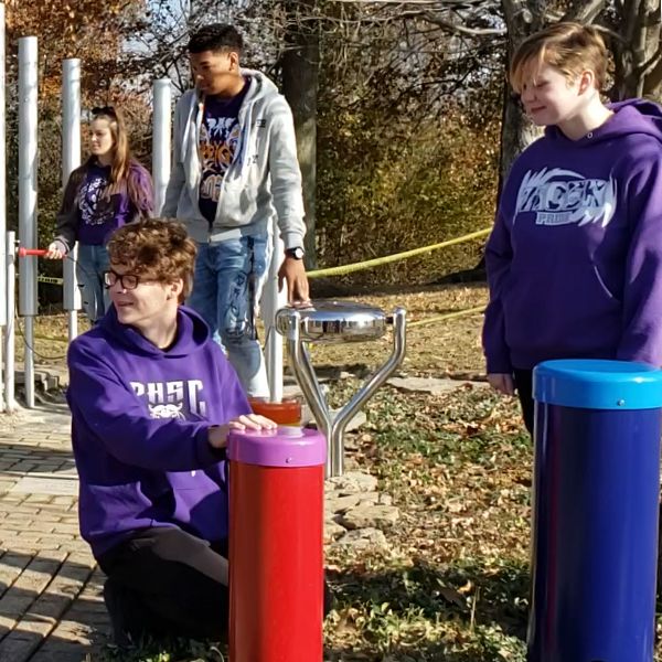 Local High School students playing on the outdoor musical instruments at new music garden at the Pickerington Library Music Garden 