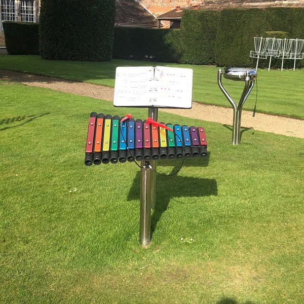 a rainbow colored xylophone installed in the music garden at north cadbury court