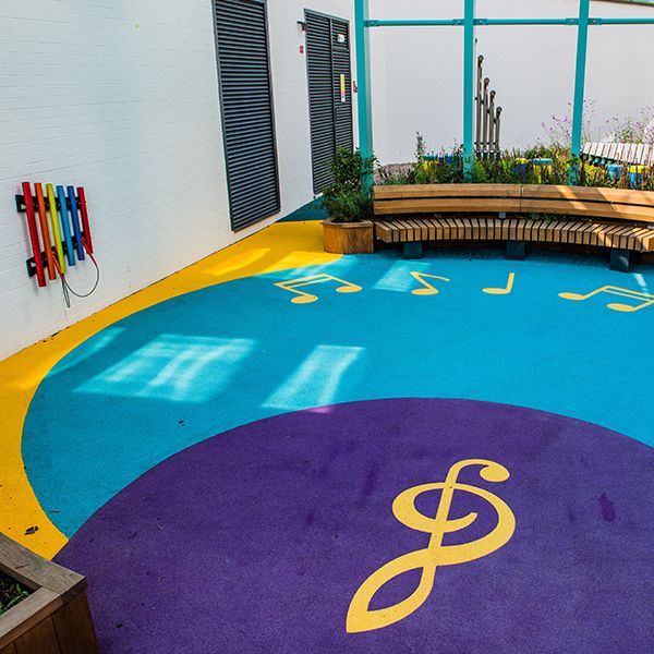 the blue and yellow flooring of the Edinburgh Children's Hospital music garden with music notes 