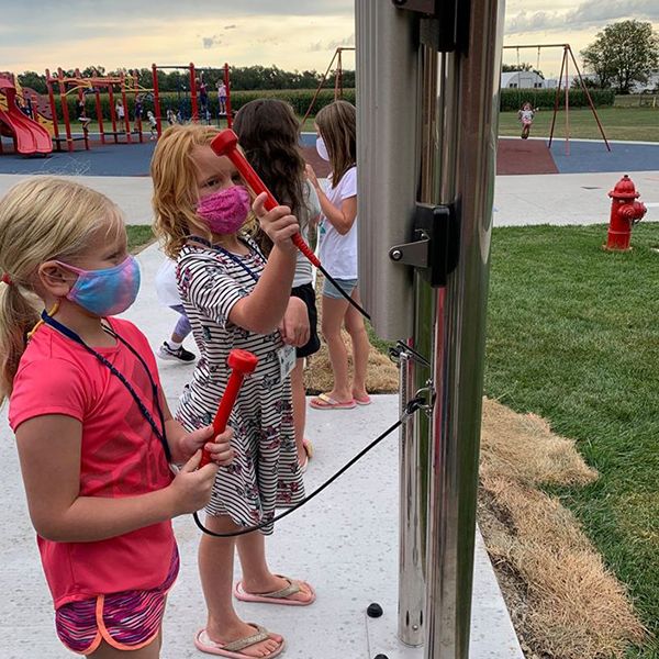 children playing on the Hastings Noon Kiwanis recently completed outdoor musical playground in the Adams Central Elementary School Playground