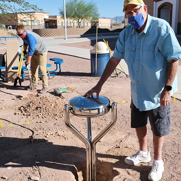 member of the Valle Verde Rotary Club installing a stainless steel babel drum