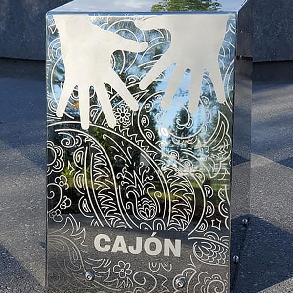 a stainless steel outdoor cajon drum in the Quinterra Legacy Musical Memorial Garden