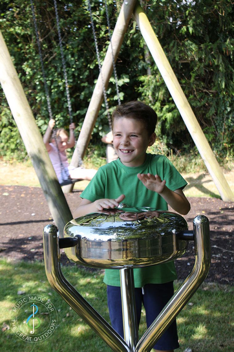 Boy Playing Stainless Steel Tongue Drum in Playground