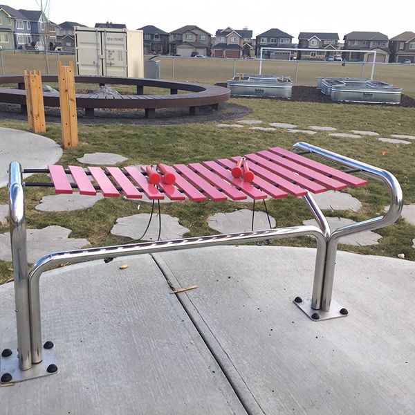 a outdoor marimba outdoor musical instruments being played in the outdoor classroom at Buffalo Rubbing Stone Elementary School in Canada