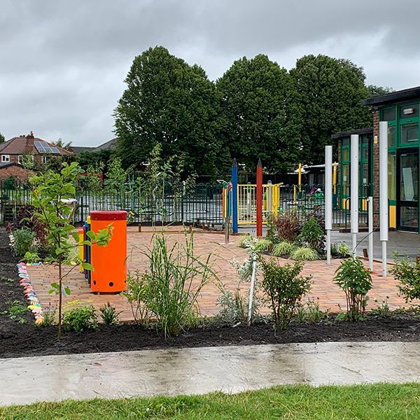 Image of a musical memorial garden full of outdoor musical instruments and rainbow coloured chimes