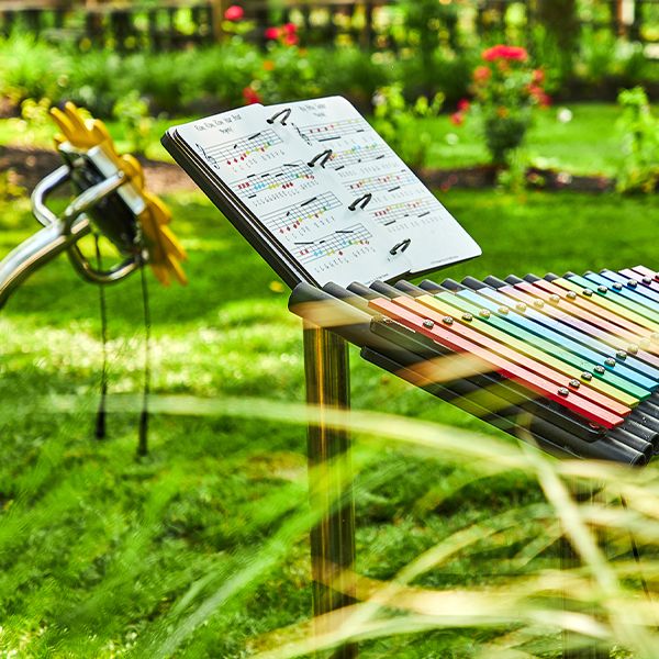 a large colorful outdoor xylophone with a music book