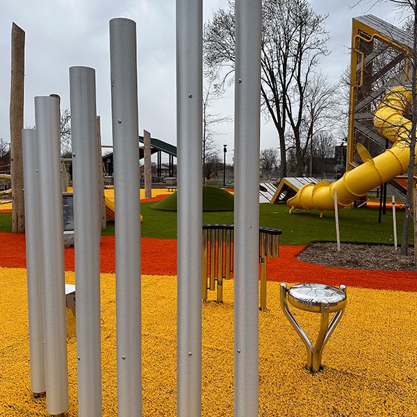 large outdoor musical instruments including chimes, handpipes and a cajon drum all made from stainless steel