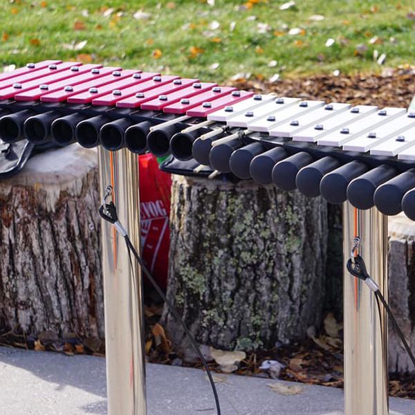 Outdoor xylophone with half pink grp notes and half aluminium notes and black resonators at the quinterra legacy garden