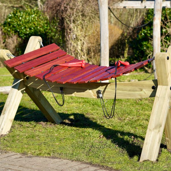a large wooden outdoor xylophone with red mallets