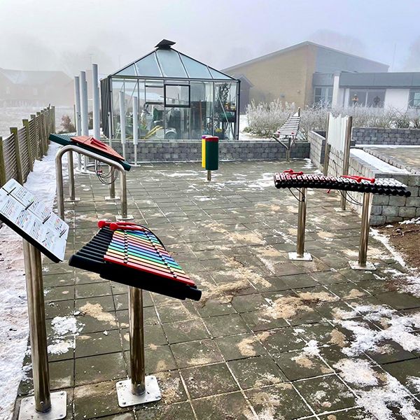 a selection of outdoor musical instruments in a care home garden denmark
