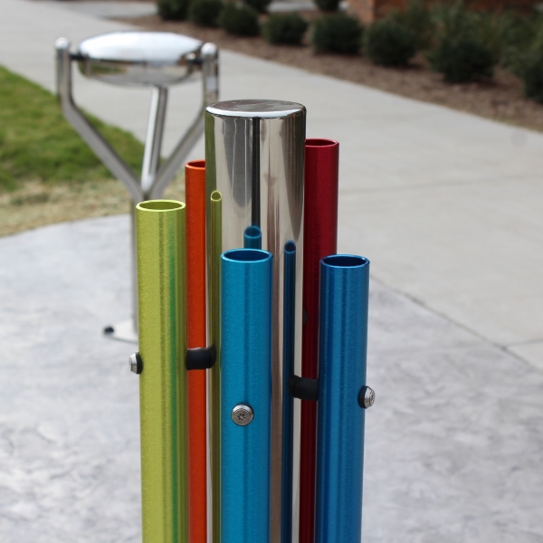 a stainless steel post with five colored aluminum chimes attached to create an outdoor musical instrument