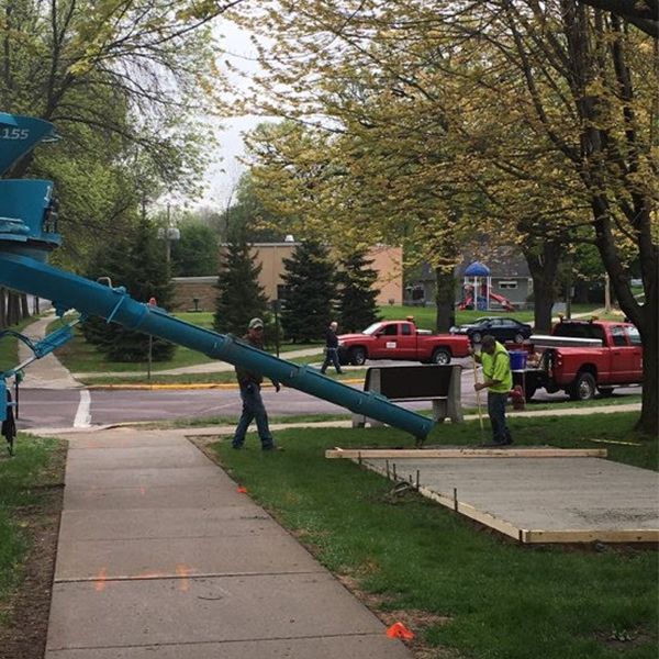 new concrete bed being laid for the new outdoor musical instruments at the north mankato taylor library