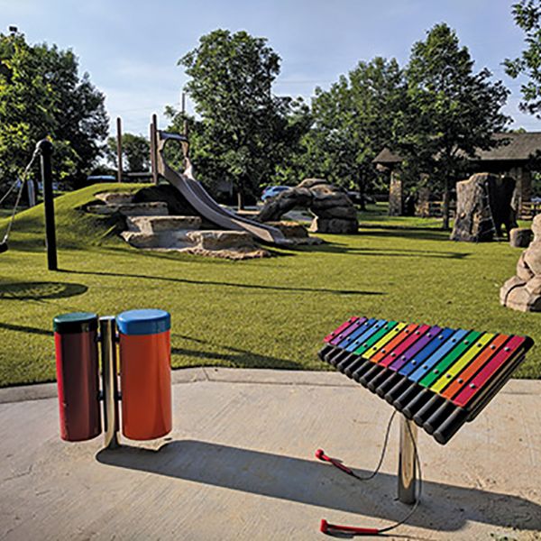 A music park featuring a rainbow cavatina outdoor xylophone and a pair of colourful outdoor conga drums 