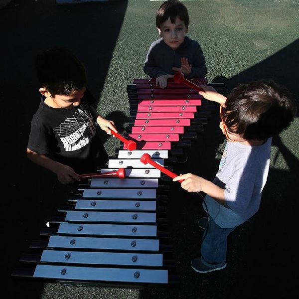 Birds Eye View of Three Children playing an outdoor xylophone in Little rock Zoo's Sensory Garden