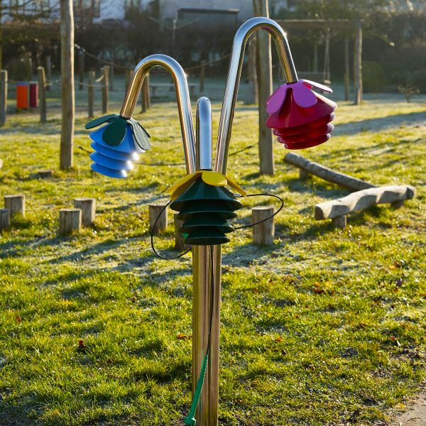 image of a large outdoor musical instrument shaped like a three flower bells on silver posts