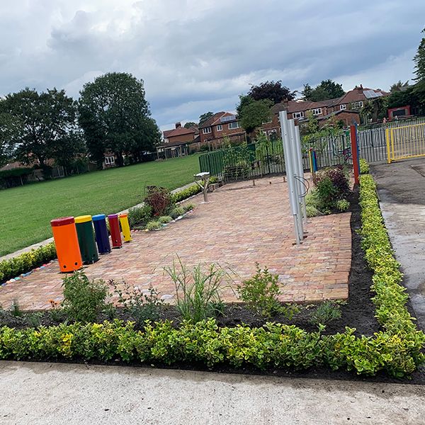 Image of a musical memorial garden full of outdoor musical instruments and rainbow coloured chimes and drums