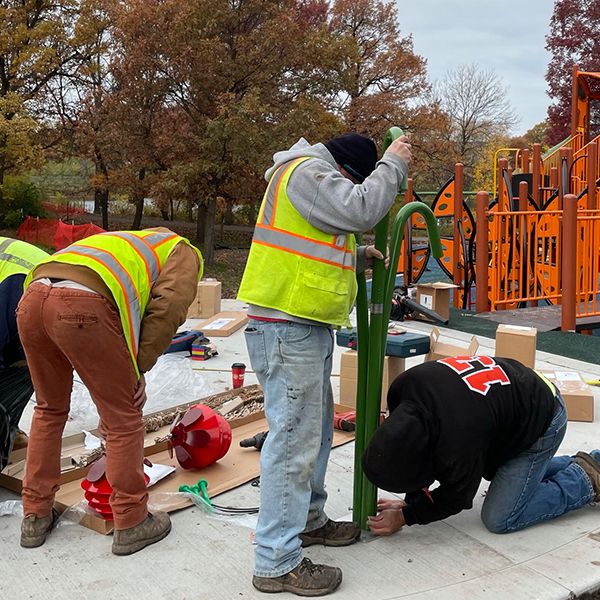 St Croix installation team creating an outdoor playground with outdoor musical instruments