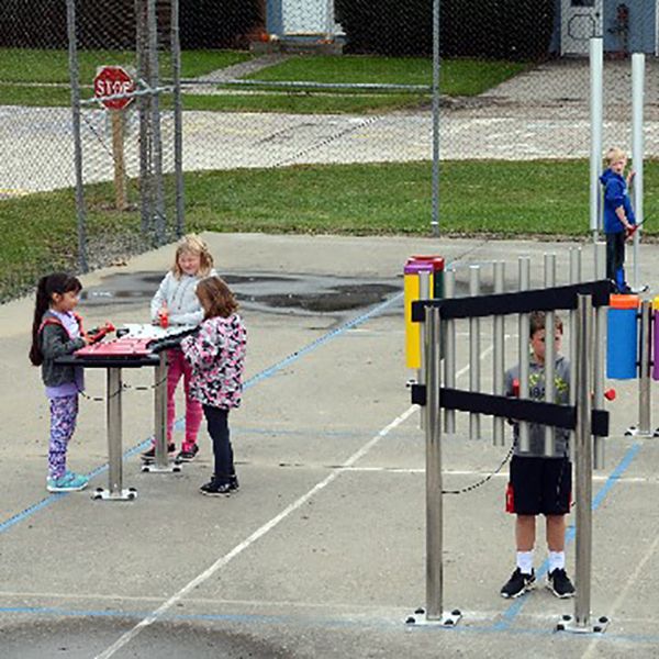 Aerial view of the children playing on the new outdoor musical instruments in the Montezuma elementary School playgrounds