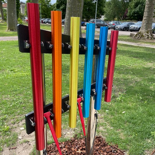 a colourful set of outdoor chimes on stainless steel posts installed on a pathway