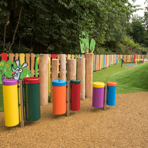 Line of colourful outdoor congas drums in Denzils Music Mayhem Outdoor Musical Park at West Midlands Safari Park