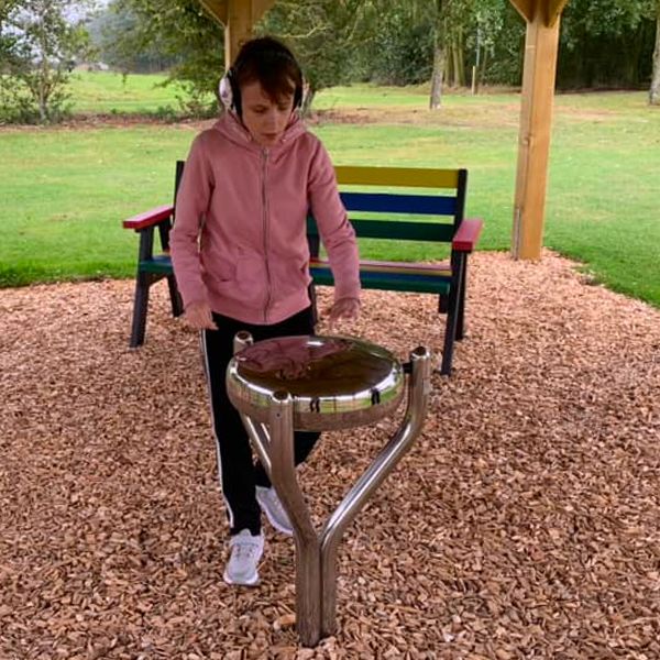 Girl playing an outdoor steel drum at the Thomas Centre