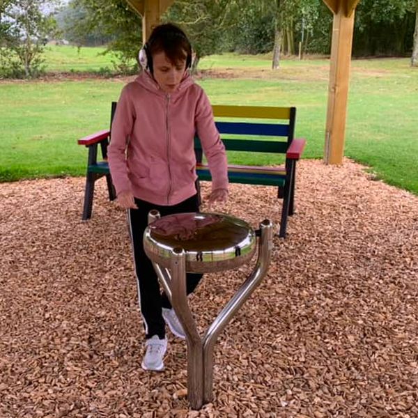 Girl playing an outdoor steel drum at the Thomas Centre