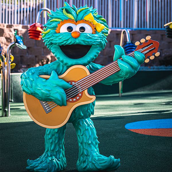 sesame street character playing a guitar in the sesame street music park at seaworld