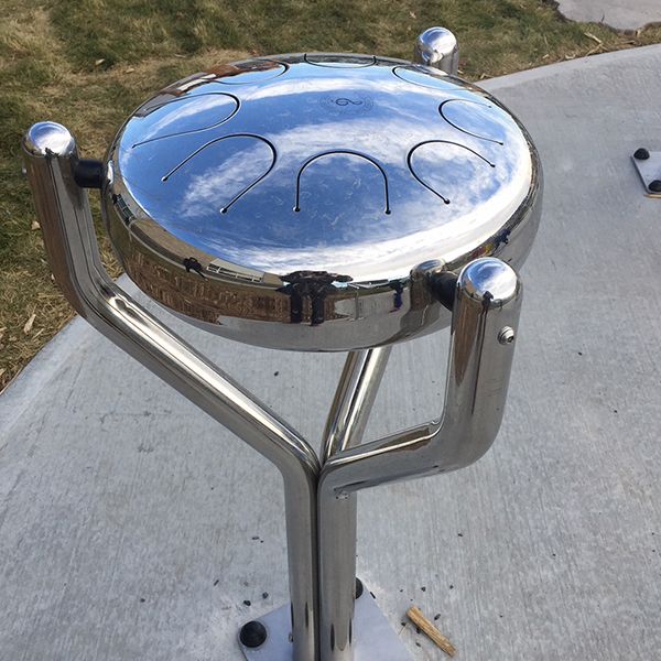 a stainless steel outdoor tongue drum outdoor musical instrument in the outdoor classroom at Buffalo Rubbing Stone Elementary School in Canada