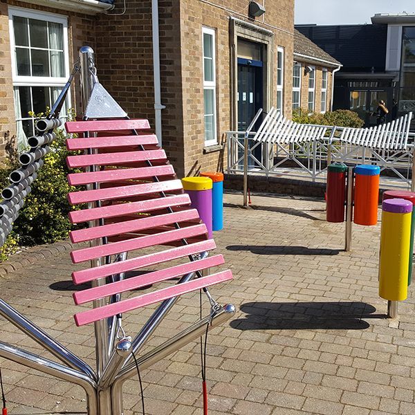 special needs school playground with outdoor musical instruments installed