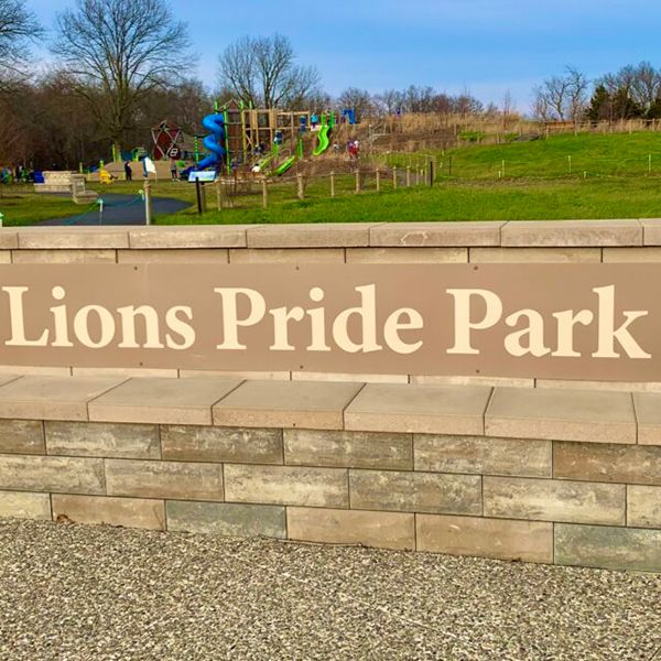 Wall with the words Lions Pride Park on it