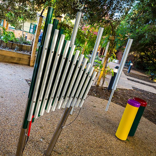 An outdoor xylophone and colourful outdoor conga drum in the Aldeburgh Sensory Garden