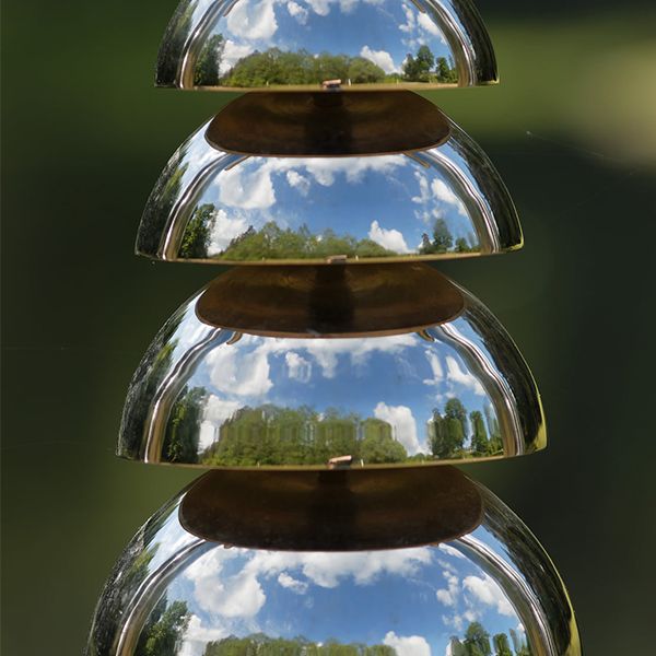 close up image of a stainless steel bell lyre outdoor musical instrument