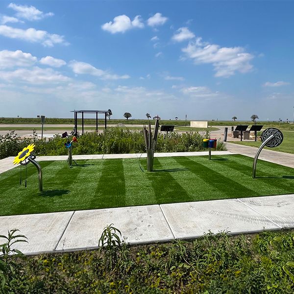 five outdoor musical instruments on a lawn at the Kansas Wetlands Center