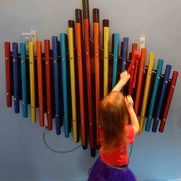 a rainbow coloured wall xylophone located in the cape cod children's museum music room