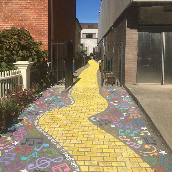 A yellow brick pathway leading to the gateway into the new Go Art! Play Me A Tune Music Garden