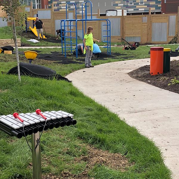 work being carried out in the sensory garden at the Iowa Women's Prison with a small outdoor xylophone in the foreground